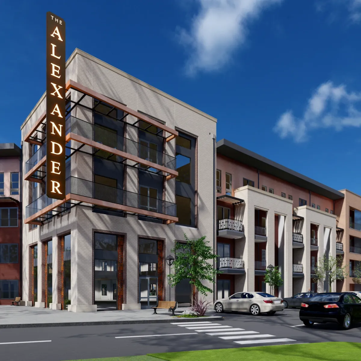 Modern apartment building named "The Alexander" with cars parked along the street on a sunny day.